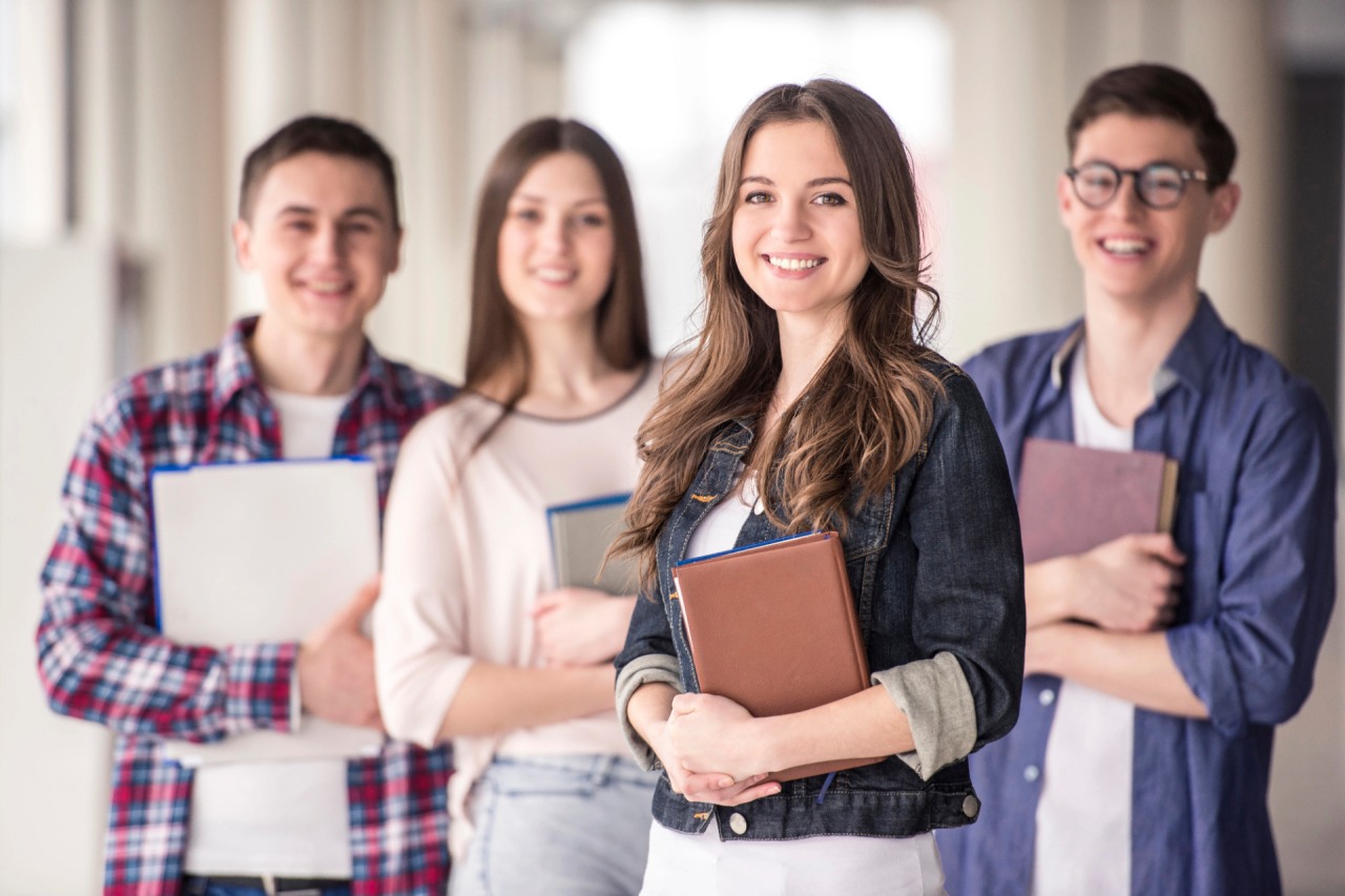 Group of happy young students in a university.